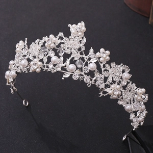 Exquisite bridal crown with white pearls and sparkling crystals in floral silver design