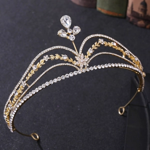 Close-up of golden bridal tiara with sparkling cubic zirconia and floral leaf details