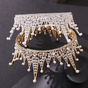 Macro shot of silver and gold Baroque bridal crowns with sparkling crystals and white pearls