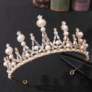 Baroque gold bridal crown featuring white pearls and sparkling rhinestones on dark base