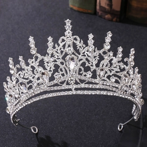 Macro detail of silver baroque tiara featuring intricate vine design and sparkling rhinestones
