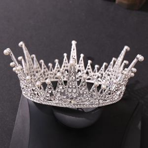 Luxurious silver bridal crown with sparkling rhinestones and pearls on black background