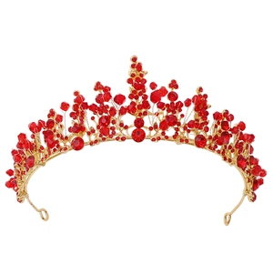 Detailed view of handmade gold bridal crown featuring vibrant red crystals and beads