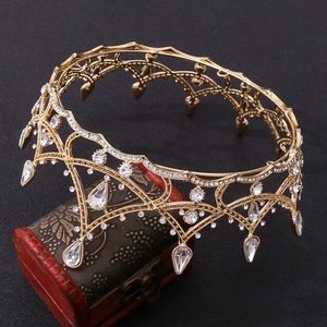 Detailed view of luxury gold baroque crown with sparkling crystals and drop pendants