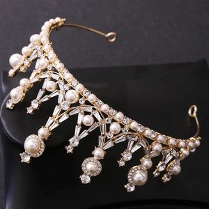 Detailed macro view of golden bridal crown with white pearls and sparkling rhinestones