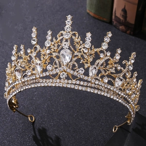Detailed close-up of Baroque gold crown featuring sparkling rhinestones and teardrop crystals
