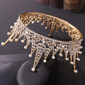 Detailed macro view of baroque gold leaf tiara with crystals and faux pearls