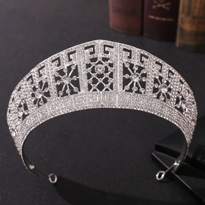 Detailed close-up of a silver bridal tiara featuring shimmering rhinestones on black background