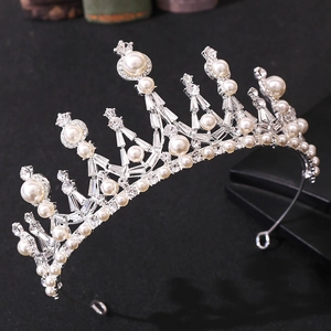 Close-up of elegant silver crown with white pearls and sparkling crystal rhinestones