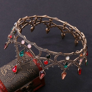 Close-up of Baroque black bridal crown with multi-color crystals and vintage gold metal detail