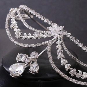 Close-up of sparkling floral bridal headband with rhinestone tassels and silver detailing
