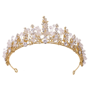 Elegant gold bridal crown with red crystals and handcrafted beadwork on white background