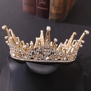 Detailed close-up of luxury Baroque gold crown with sparkling crystals and white pearls