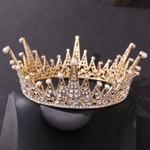 Detailed close-up of Baroque golden leaf crown with crystals and round white pearls