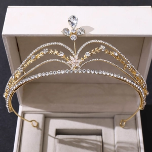 Elegant gold bridal crown with floral rhinestone design in an open jewelry box