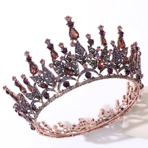 Close-up of vintage Baroque bridal crown with red crystals and bronze leaf patterns