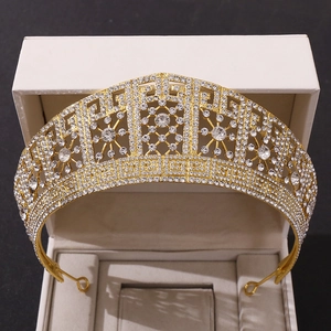 Close-up of luxury Baroque bridal crown with white crystals and gold zinc alloy finish
