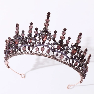 Détail de la couronne en bronze vintage avec strass rouges et motifs filigranés ciselés