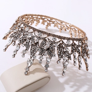 Detail of baroque bridal crown with leaf motifs and red water-drop crystal pendants