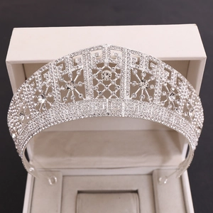 Detailed close-up of sparkling silver bridal crown with rhinestones in a white gift box
