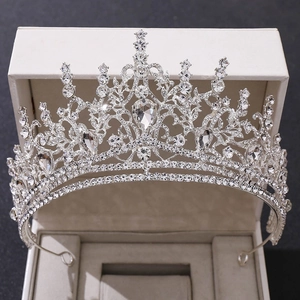 Macro shot of silver baroque crown showing intricate rhinestones and metal details