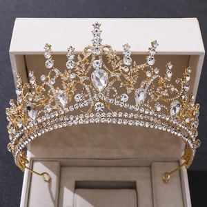 Macro shot of luxury gold bridal tiara with sparkling white rhinestones and water drop crystals