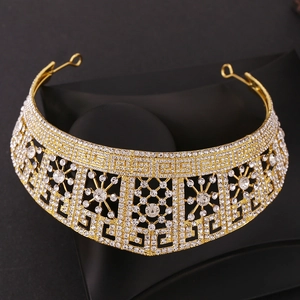 Macro detail of golden baroque bridal crown with shimmering rhinestones and intricate patterns