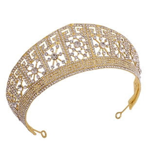 Macro detail of golden bridal crown with sparkling rhinestones and Greek key patterns