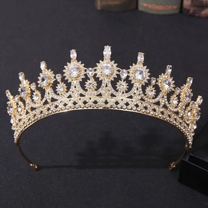 Detail of a golden bridal crown with starburst motifs and sparkling zircon on dark texture