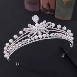 Detailed 45-degree side view of bridal crown with rhinestones and white pearls