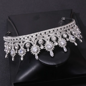 Detail of silver bridal crown with shimmering zircons and floral patterns on black stand