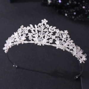 Detail of silver bridal headband with crystal flowers and leaf rhinestones for wedding