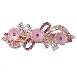 Detail einer eleganten roségoldenen Haarspange mit Resinfunktion und lila Kristallen