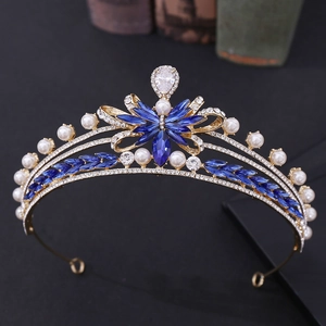 Detailed macro of golden bridal crown with blue crystals, white pearls and sparkling zircons