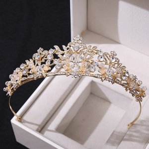 Exquisite gold bridal headband with sparkling crystals and rhinestones on a gift box