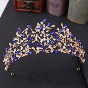 Detail of vintage bridal crown with blue marquise gems and crystals on a rustic background