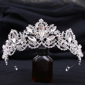 Elegant silver bridal crown with crystal stones and AB rhinestones on a glass base