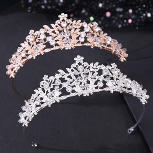 Close-up of bridal crowns in rose gold and silver with leaf motifs and rhinestones