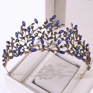 Detailed close-up of vintage baroque tiara with bronze leaves and dark blue rhinestones