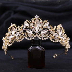 Detailed view of intricate gold crown featuring sparkling crystals and leaf patterns