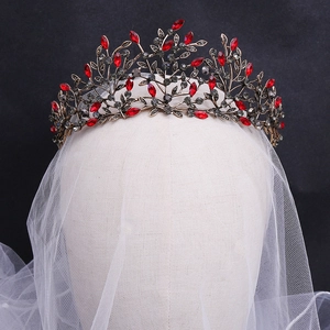Detailed view of Baroque bronze leaves and red rhinestones on a vintage bridal crown