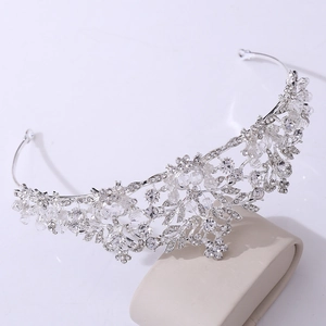Detail of silver bridal crown featuring delicate crystal beads and rhinestone leaf accents