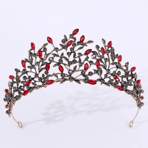 Close-up of vintage bronze leaf bridal crown with red and black rhinestones detail