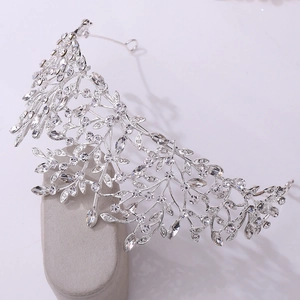 Macro detail of luxurious bridal tiara featuring silver leaf designs and sparkling crystals