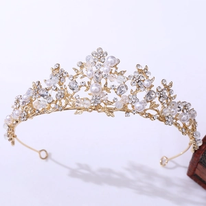 Detailed view of silver bridal crown with white pearls and sparkling crystals on wood