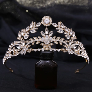 Macro shot of leaf-shaped bridal crown with zircon stones on an elegant golden frame