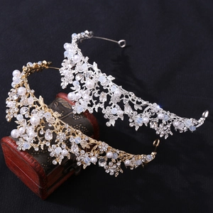 Close-up of handmade bridal tiara with pearls, rhinestones, and silver leaf details