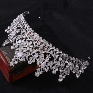 Macro detail of silver bridal crown with 3A cubic zirconia on a vintage red jewelry box