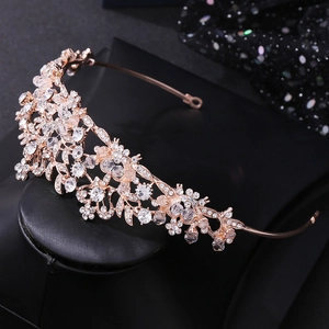 Close-up of rose gold bridal headband featuring leaves and shimmering crystal beads