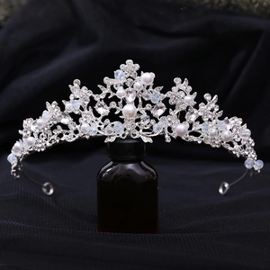 Close-up of handmade bridal tiara with pearls and crystals on silver branch frame